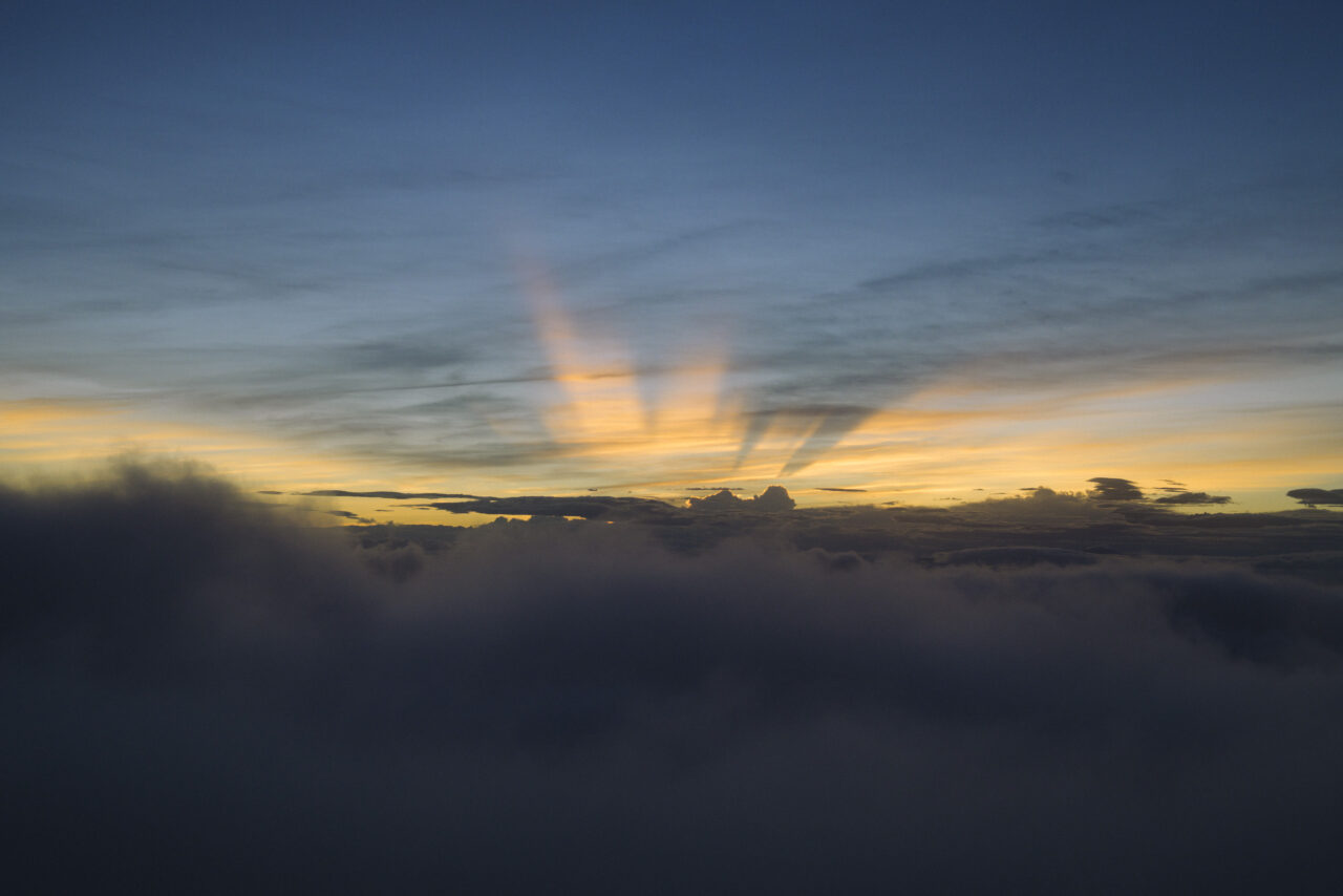 太陽の光が空に浮かぶ、夜明け