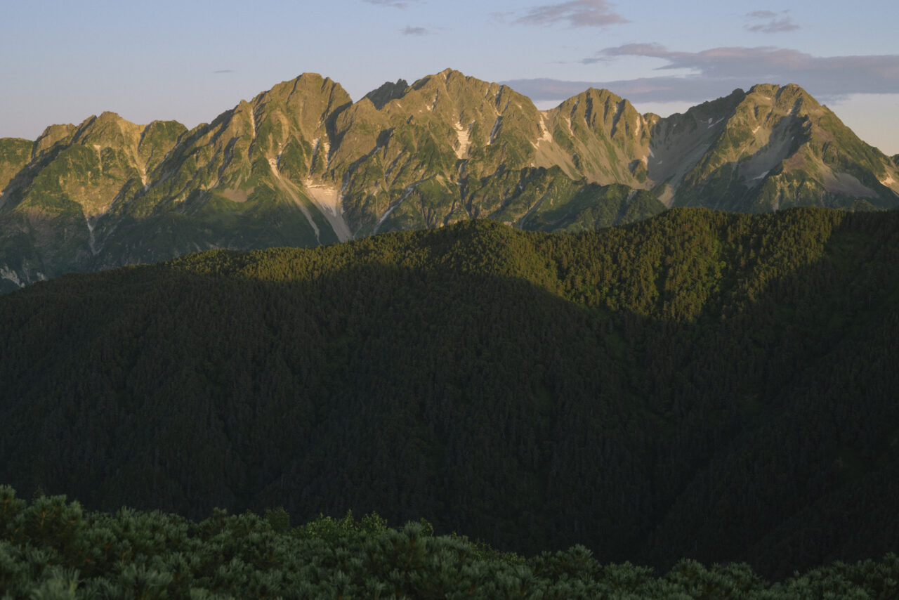 夜明けの光に黄色く染まる穂高連峰