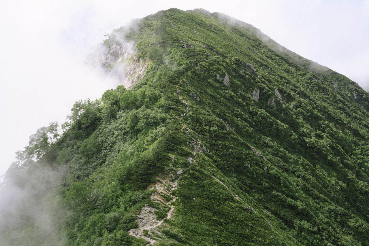 檜尾岳山腹とそれを登る人々
